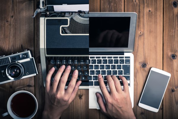 Half screen of laptop and the other half a typewriter 